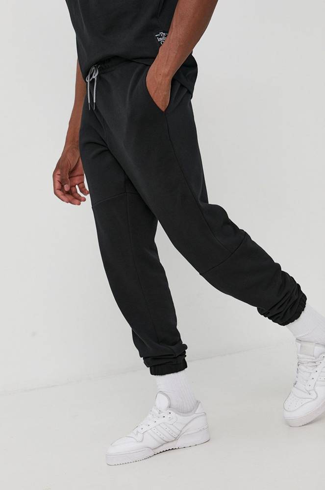 Nohavice New Balance pánske, čierna farba, jednofarebné