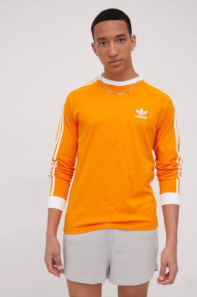 Bavlnené tričko s dlhým rukávom adidas Originals Adicolor HE9531 oranžová farba, s nášivkou